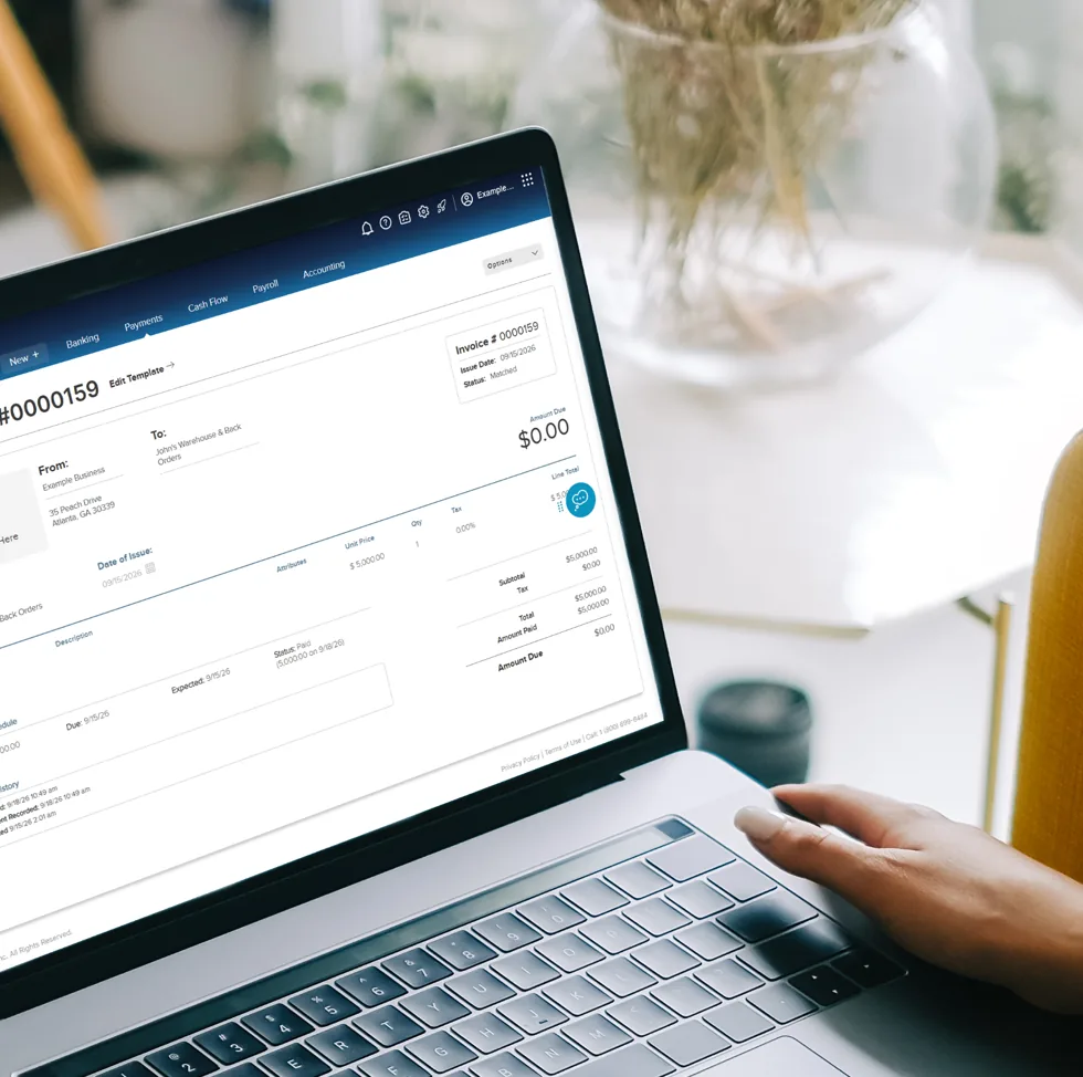 A FINSYNC invoice open on a laptop