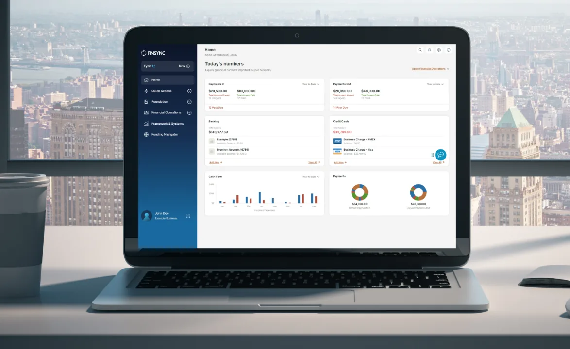 FINSYNC open on a laptop showing an operating account with balances, pending deposits, and recent transactions.