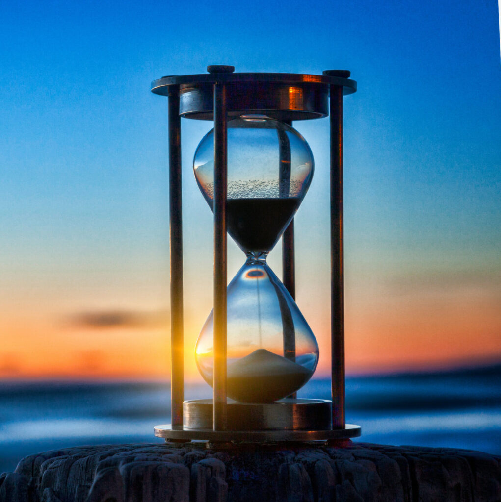 hourglass with sunset in the background