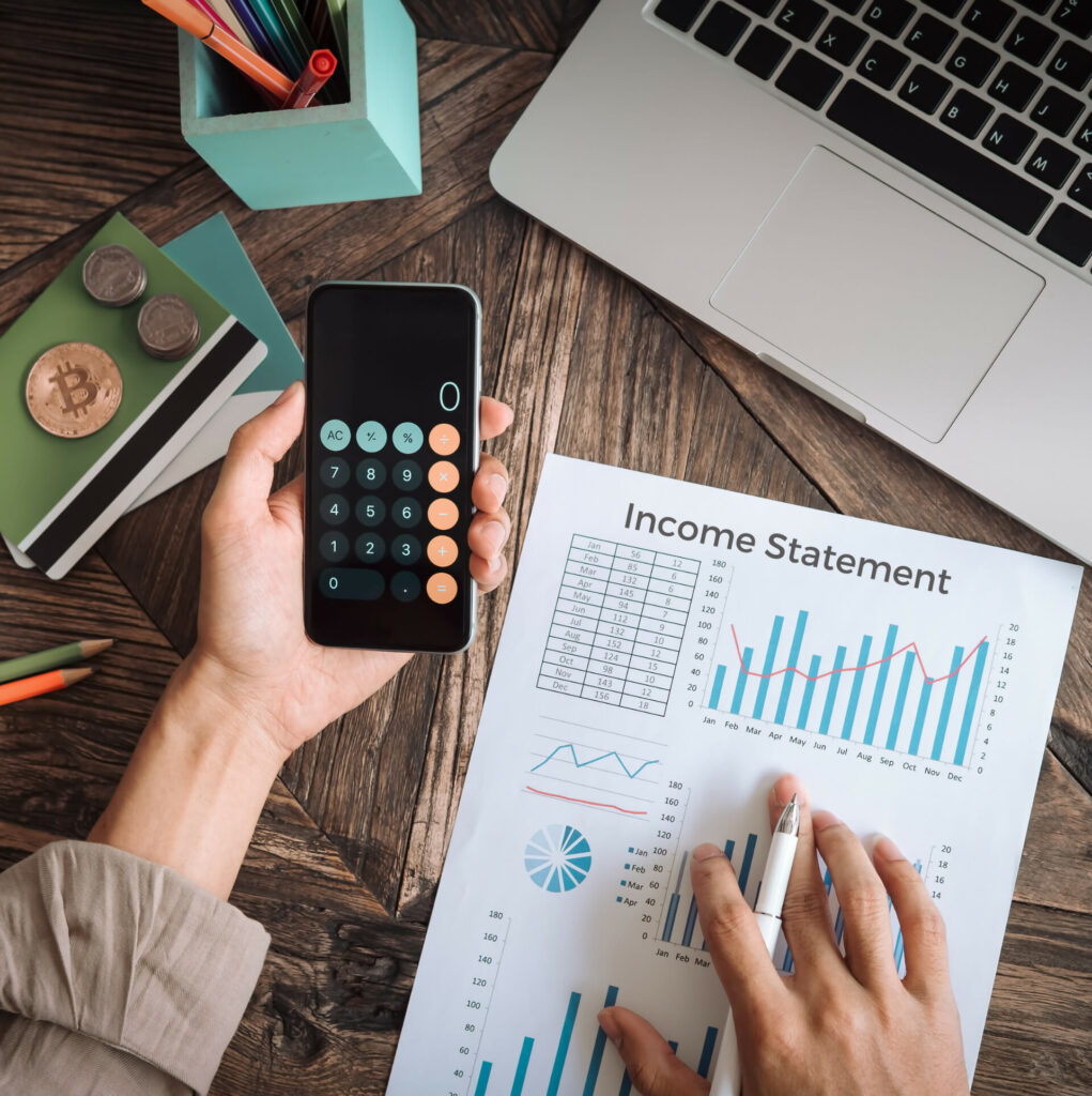 Income Statement with person writing and using a calculator