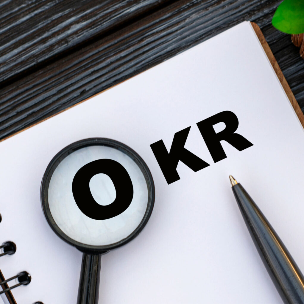 OKR with pen and magnifying glass