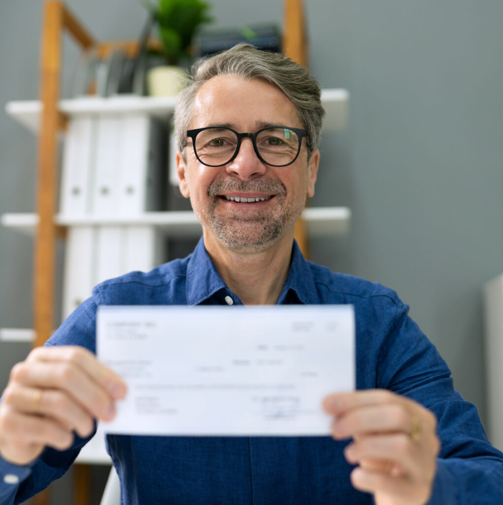 man holding a payroll check