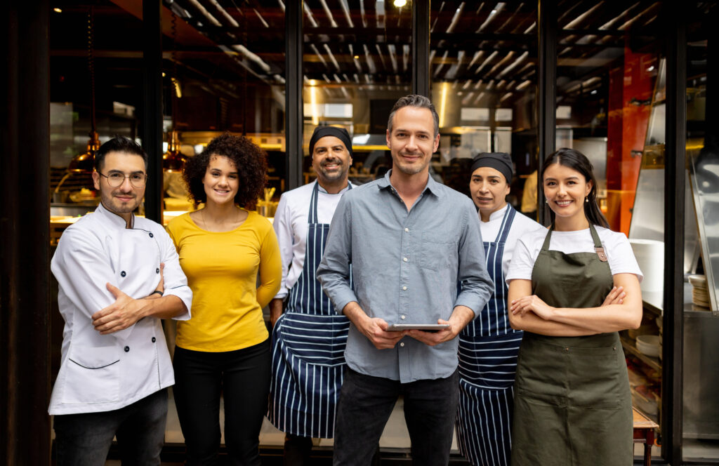 Portrait of a friendly staff working at a restaurant and looking at the camera smiling