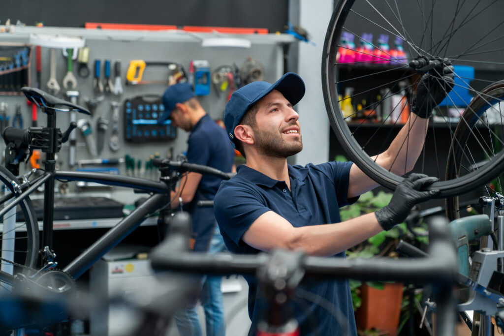 Team of mechanics working at a repair shop fixing a bicycle