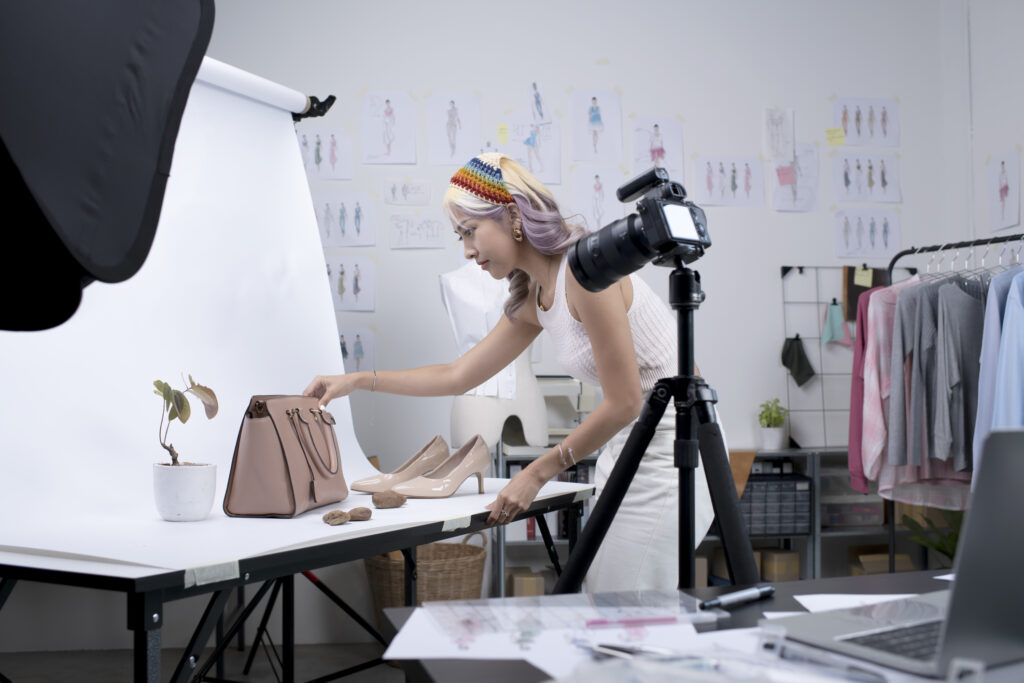 Business online influencer preparing for fashion photoshoot and live streaming using camera