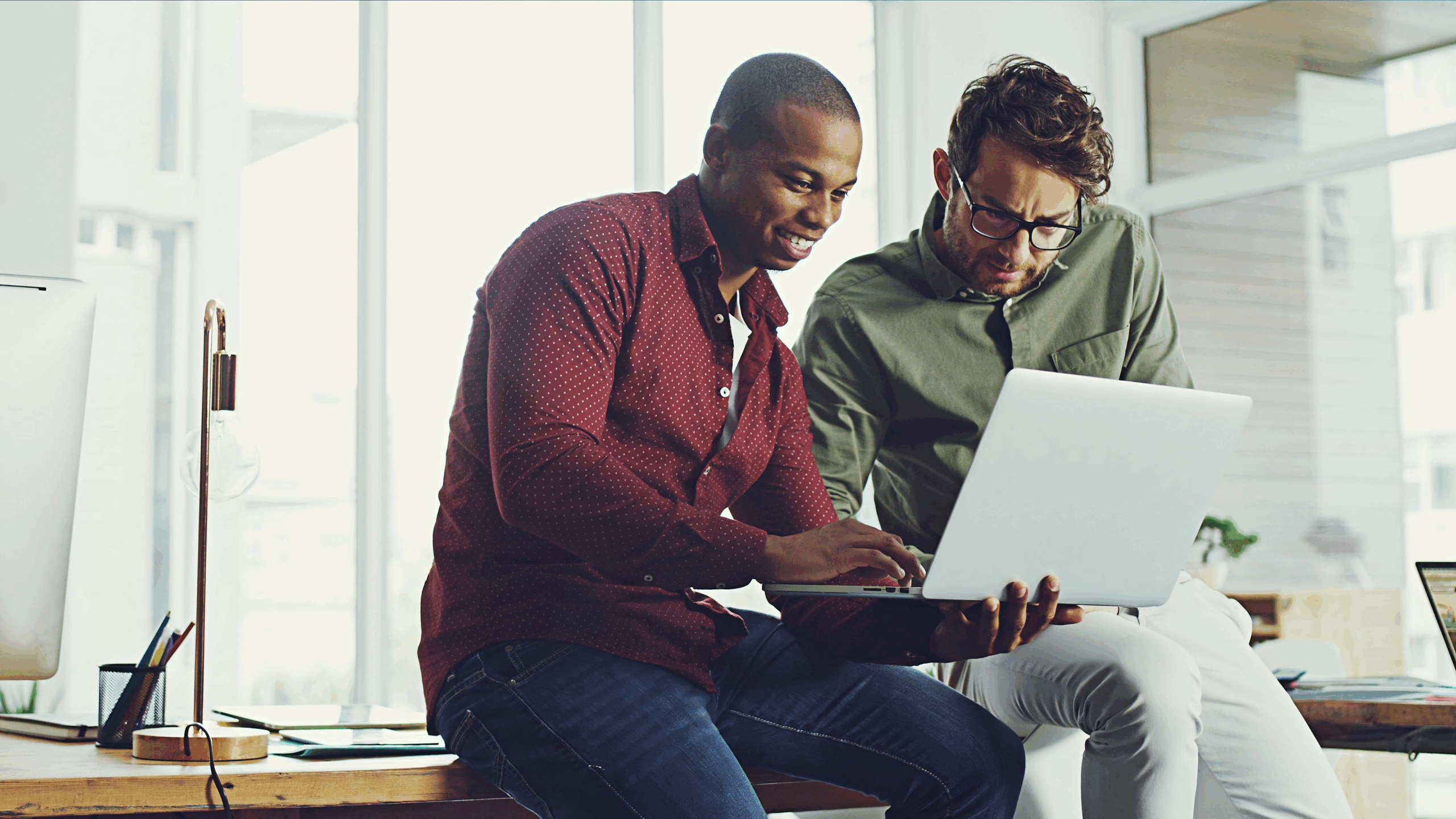 Two men working on Laptop