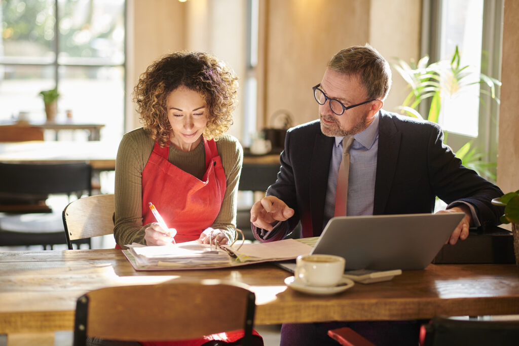 signing the business lease with a banker and owner