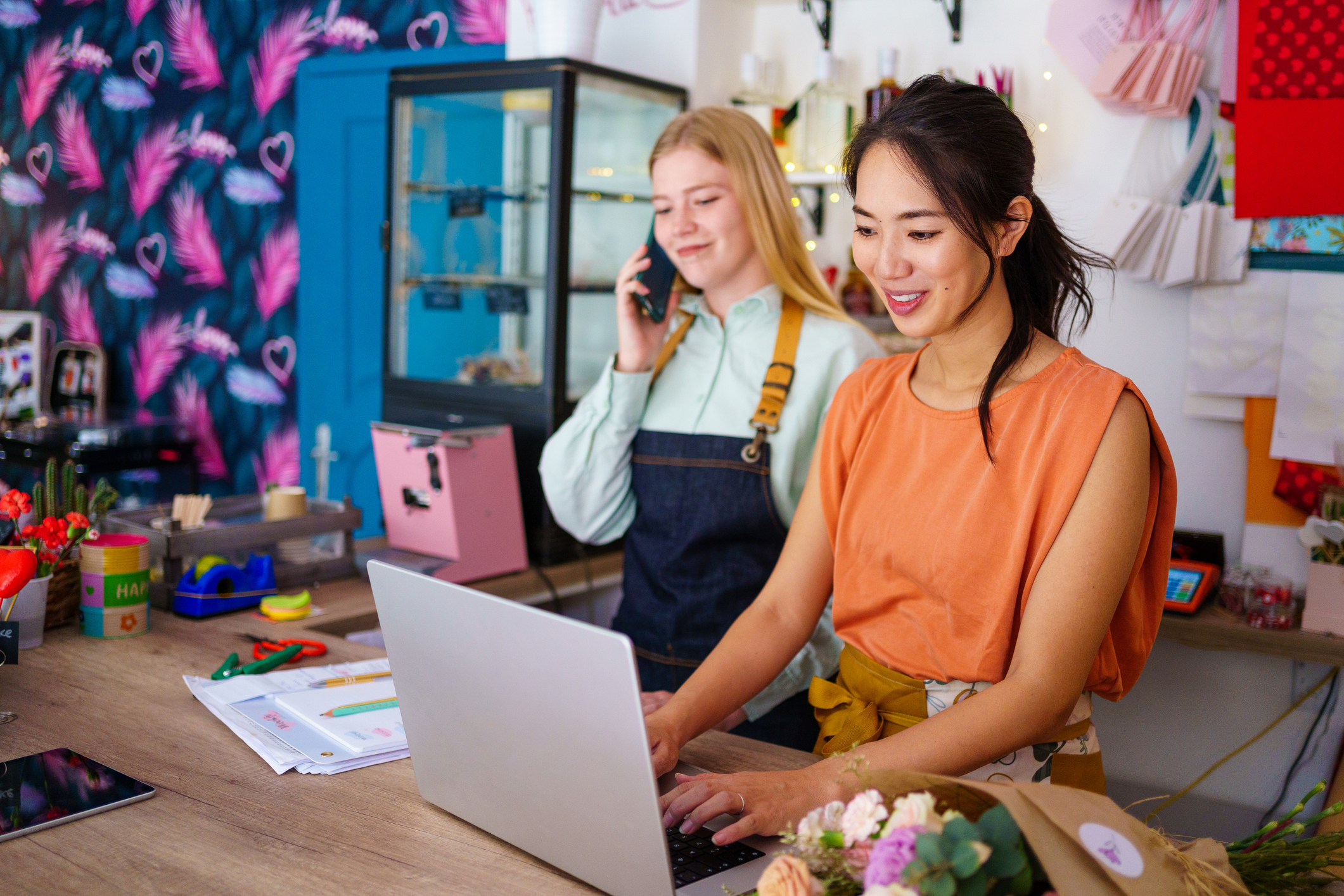 Two florists working together in flower shop