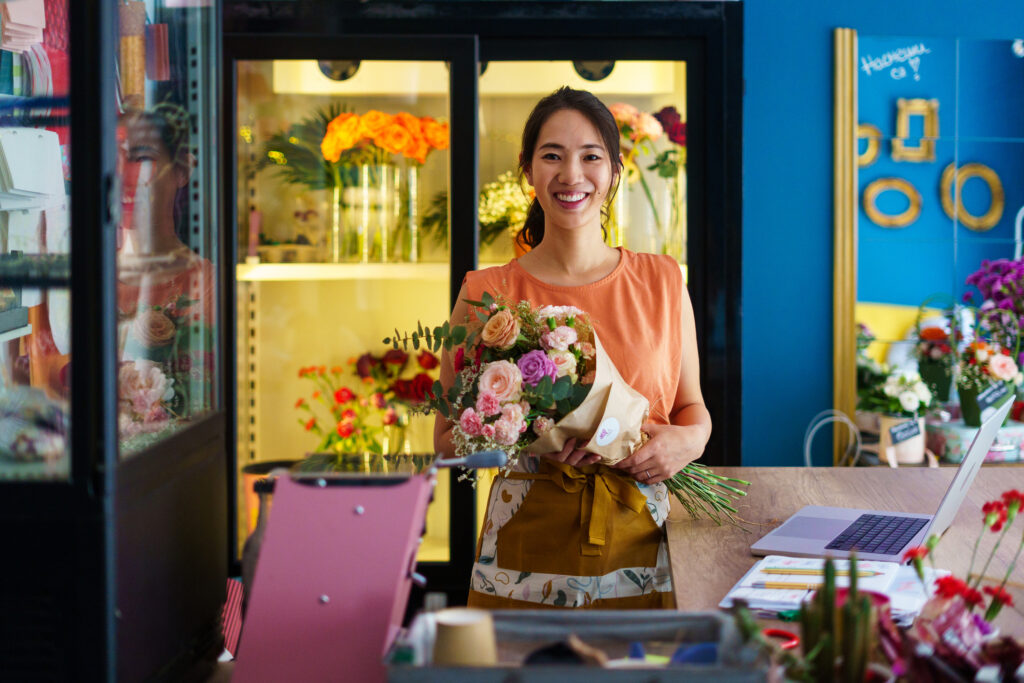 Portrait of smiling female florist in flower shop
