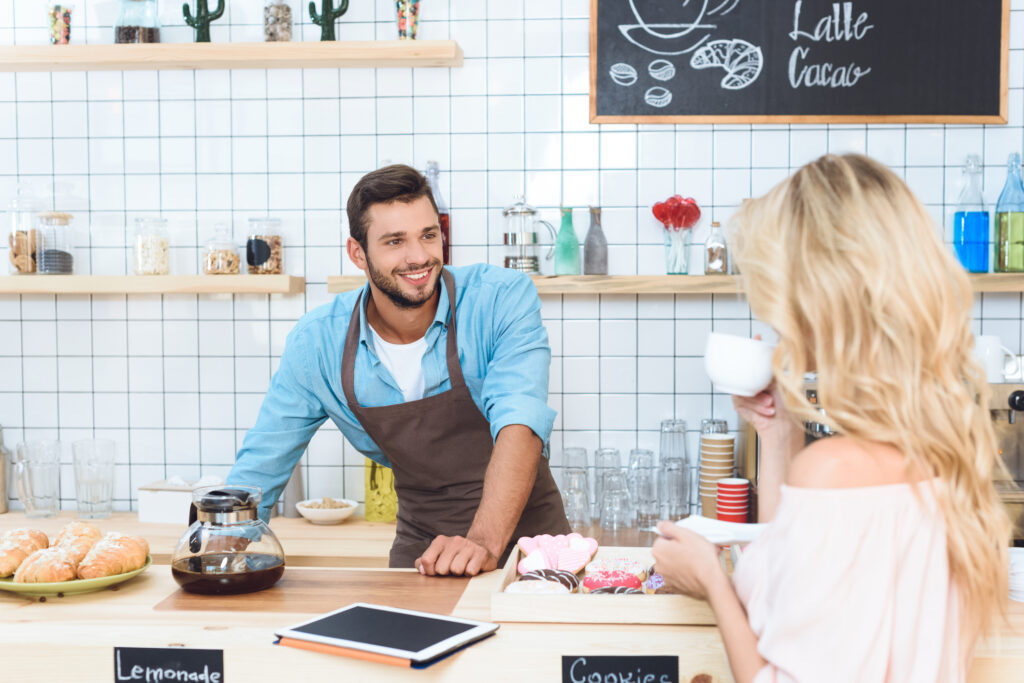 barista and woman in cafe