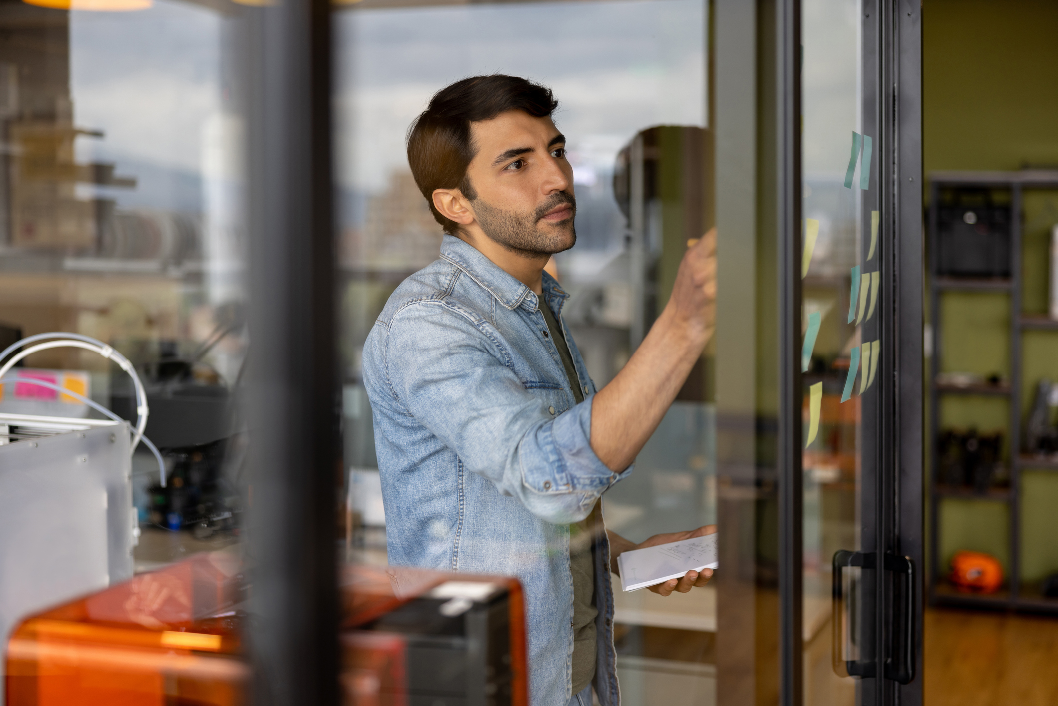 business man working at a creative office and writing ideas on a board 