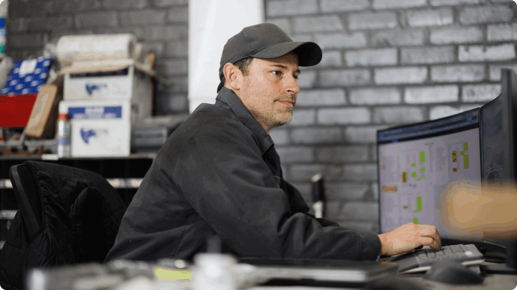 business owner sitting at his computer typing