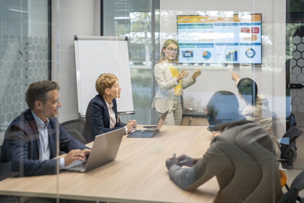 Businesswoman leading a presentation to her colleagues in the office meeting room