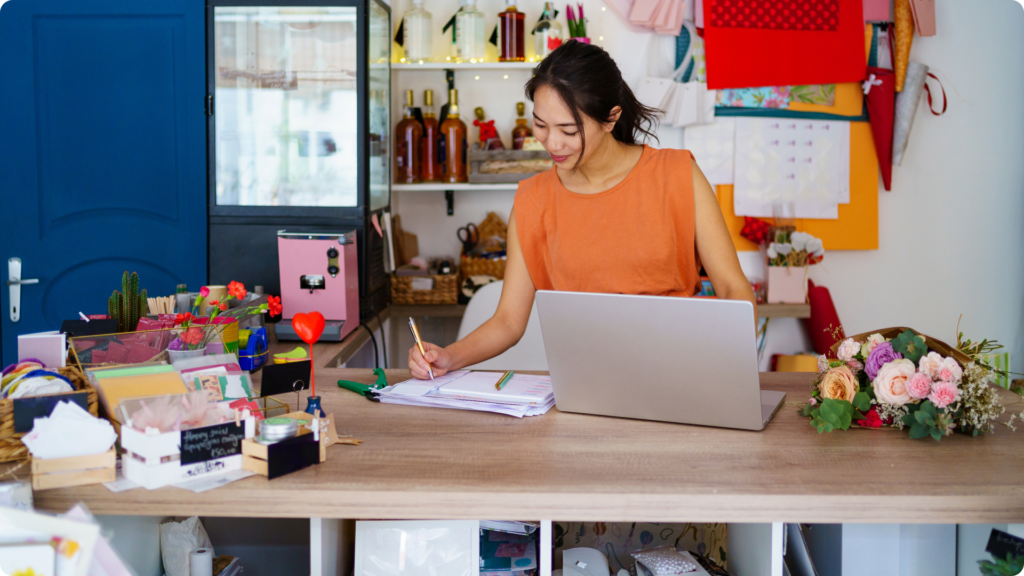 woman working in her business at her desktop computer
