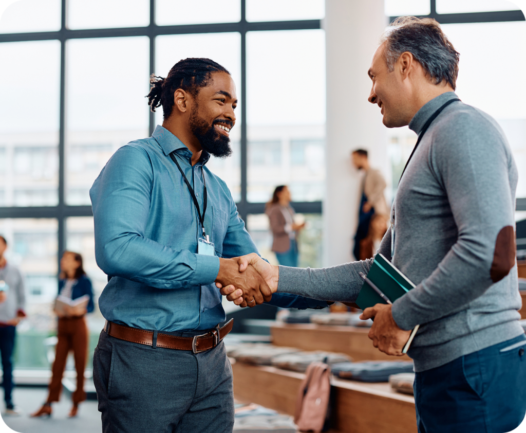 relationship banker, smiling and shaking hands with small business owners
