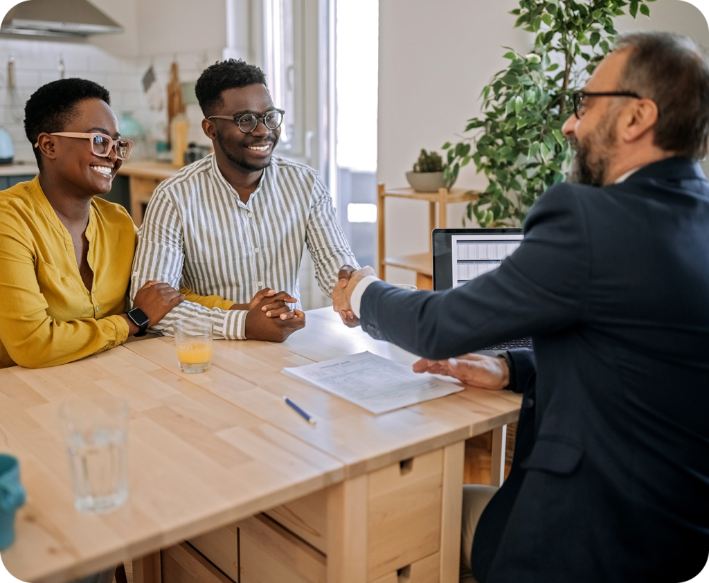 business owners shaking a man in a suit's hand