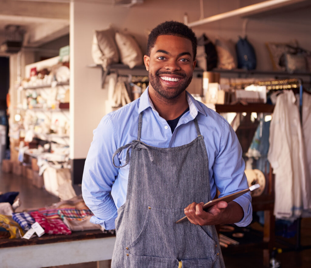 Male business Owner Of Gift Store With Digital Tablet