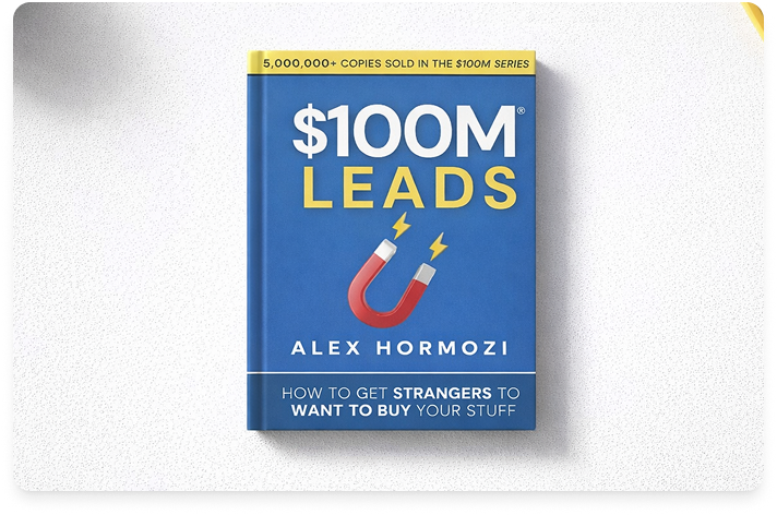 The book titled $100M Leads by Alex Hormozi laying on a white desk.